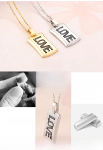 Detail showing 316L stainless steel material with engraved LOVE pendant in gold and silver
