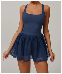 Detail of the layered mesh pleated skirt and waistline on navy blue tennis dress
