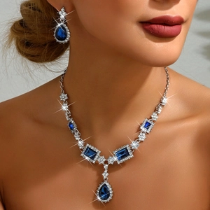 Elegant jewelry set with blue teardrop crystals and sparkling rhinestones on model