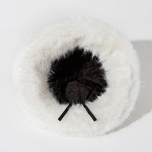 Detailed view of white faux fur bucket hat with warm black quilted lining and adjustable cord
