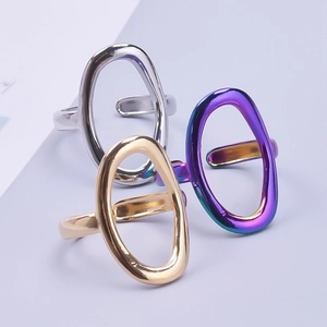 Three minimalist oval hollow rings in gold, silver and iridescent stainless steel