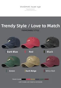 Detail of vintage washed cotton baseball caps in six colors with Sagittarius embroidery