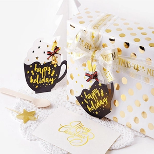 Christmas gift set with white gold-dotted box, ribbons, and festive hang tags
