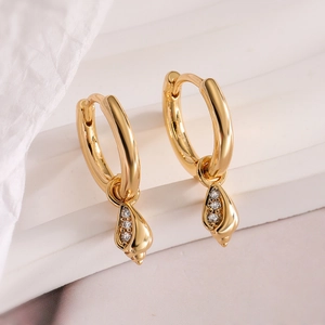 Detail of 18K gold plated hoop earrings featuring zircon-studded conch shell pendants