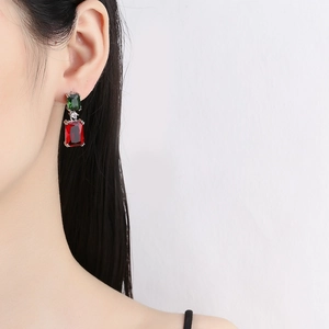 Elegant rectangle red and green drop earrings with silver base in a fashion model shot