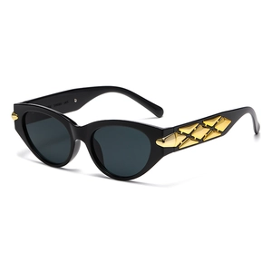 Retro cat-eye sunglasses featuring black frames with wide gold metal geometric temples