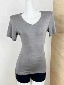 Close-up of slim-fit grey V-neck short sleeve T-shirt on a mannequin with texture detail