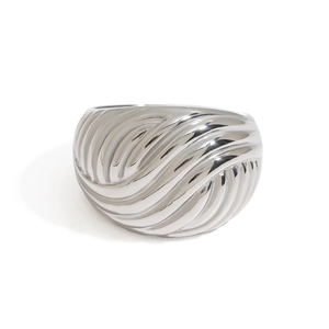Macro detail of silver stainless steel ring featuring a stylish textured ripple design