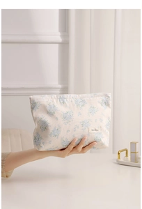 Detailed macro view of the floral canvas makeup bag with blue flower patterns