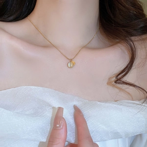 Minimalist gold stainless steel necklace with round cat eye stone on fashion model
