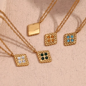 Detail view of gold-plated twisted rope chains with colorful four-stone diamond pendants
