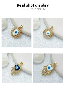Detail of four gold evil eye and Hamsa hand pendants with cubic zirconia and enamel finish