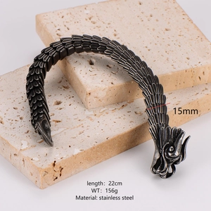 Unique stainless steel dragon head bracelet with black scale texture on stone background