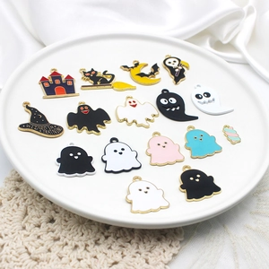 Assorted Halloween alloy charms featuring colorful ghosts and wizard hats on a white tray