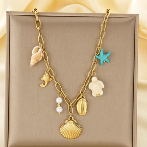 Ocean theme stainless steel necklace with starfish, shell, and pearl charms on gold chain