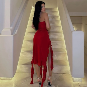 Detailed back view of a red strapless evening dress with ruffled hem and high slit