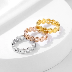 Detailed macro view of three Chinese money coin rings in gold, rose gold, and silver