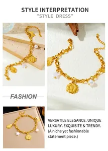 Detailed macro view of gold plated chain bracelet with heart, flower and star charms