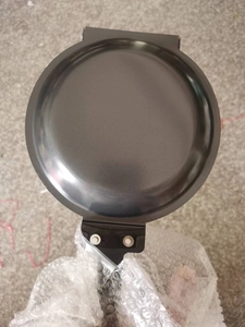 Detailed top view of a non-stick black round pan with a secure handle for breakfast cooking
