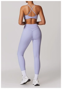 Detail of lavender high-waist yoga leggings with criss-cross back sports bra and V-shape contour