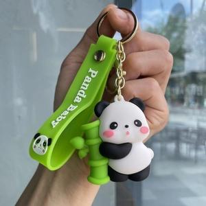 Close-up of cute panda plush keychain holding bamboo with green Panda Baby wrist strap