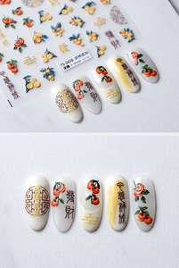 Detail of 3D embossed nail stickers featuring persimmons, golden clouds and lucky charms