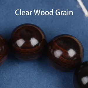 Polished ebony wood prayer beads bracelet with natural dark grain and smooth finish