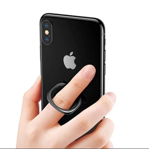 Detail showing hand holding a smartphone with black metal finger ring stand for secure grip