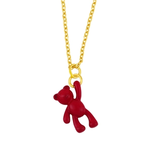 Detail of a matte dark red bear pendant hanging on a delicate minimalist gold chain