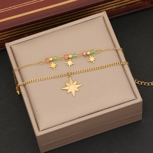 Detail of double-layer gold star bracelet with colorful crystal beads on jewelry box