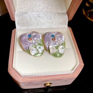 Retro floral stud earrings with purple and green enamel in a pink velvet jewelry box