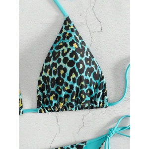 Detailed view of turquoise leopard print bikini top with adjustable halter neck straps