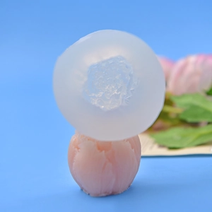 3D tulip flower silicone mold with finished pink petal candle on blue background