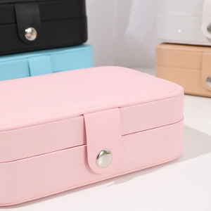 Detailed view of colorful PU leather jewelry boxes with metallic button closure