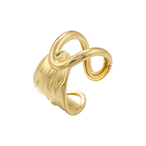 Close-up of golden irregular twisted sculptural ring with high polished metallic finish