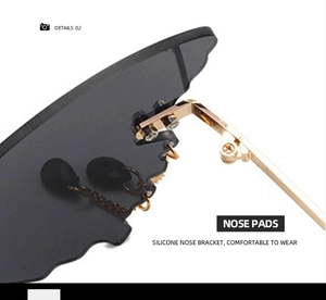 Detail of adjustable silicone nose pads and gold metal frame on butterfly sunglasses
