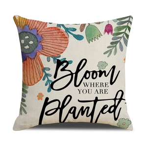Detailed view of linen pillowcase texture with watercolor flowers and Bloom quote