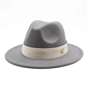 Detailed texture of grey wool fedora with beige decorative ribbon and gold M logo