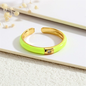 Detail of neon yellow-green 18K gold-plated ring with a sparkling inset zircon stone
