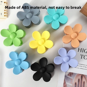 Detailed overhead view of durable ABS flower hair claws in eight vibrant colors