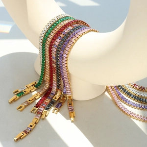 Golden titanium steel bracelets with colorful square-cut zircon stones on a white stand