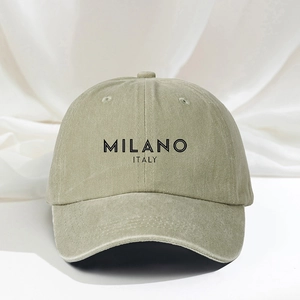 Detail of MILANO ITALY print on washed olive cotton baseball cap with vintage texture