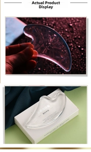 Detailed view of a transparent crystal heart gua sha tool with its retail packaging box