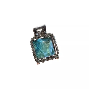 Blue resin mini hair claw clip with crystal rhinestones on a metal base for women