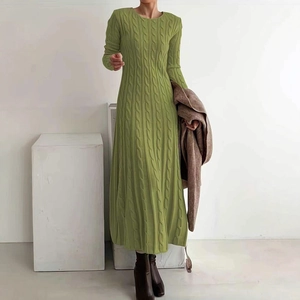 Detail shot of the grass green cable knit texture on a long-sleeved midi sweater dress