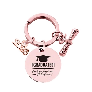 Detail of rose gold graduation keychain with 2026 charm and engraved round pendant