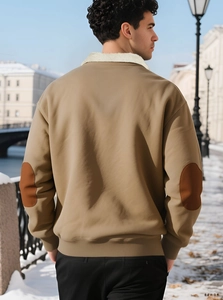 Detail of khaki jacket with white fleece collar and dark elbow patches from a back view