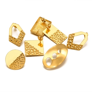 Gold geometric stainless steel earring components with hammered texture on white background