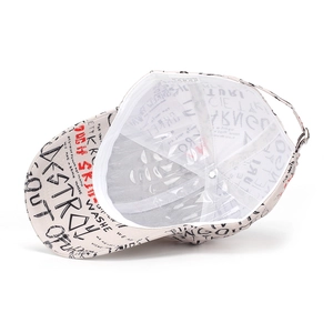 Detail view of graffiti baseball cap interior showing 100% polyester wash label