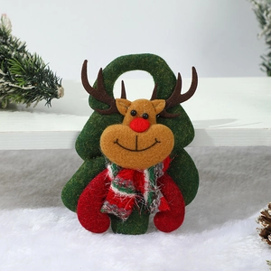 Detail of felt reindeer ornament with green tree background for Christmas decoration